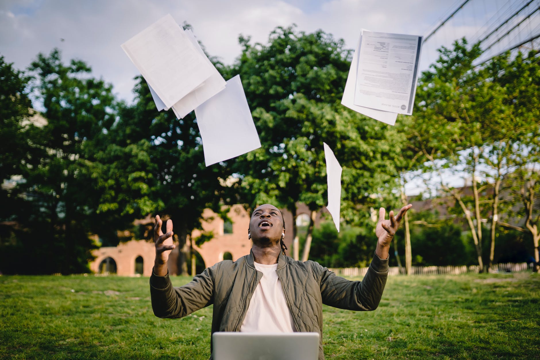 graduate with resumes and laptop excited about getting job interview