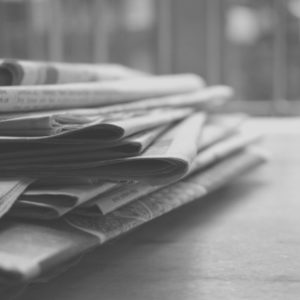 black and white pile of newspapers