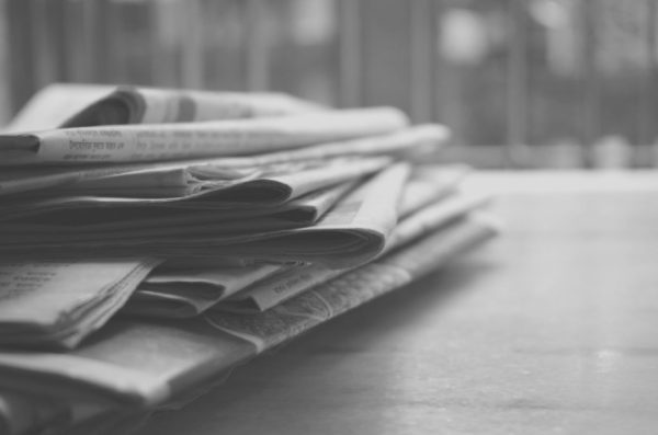 black and white pile of newspapers